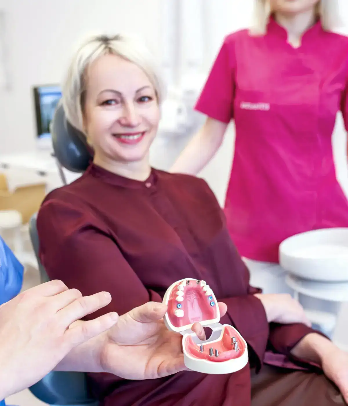 A smiling woman at Implantis Dental Clinic in Krakow.